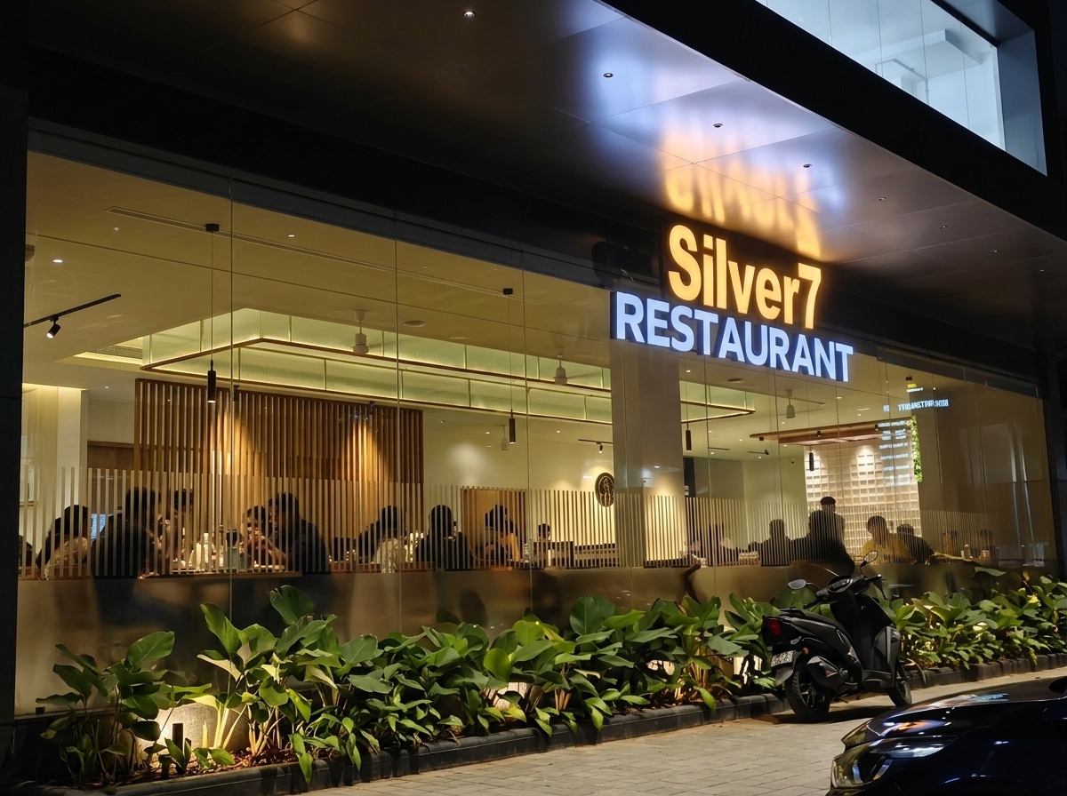 Silver 7 Restaurant illuminated architectural glass facade at night
